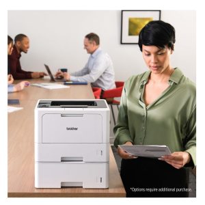 Woman using office printer in a workplace setting.